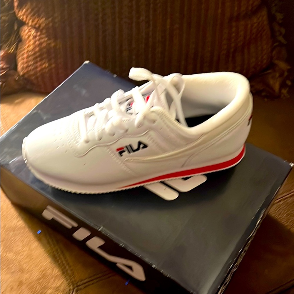 Women’s Fila’s Sports Style white gym shoes new in box with original packaging.